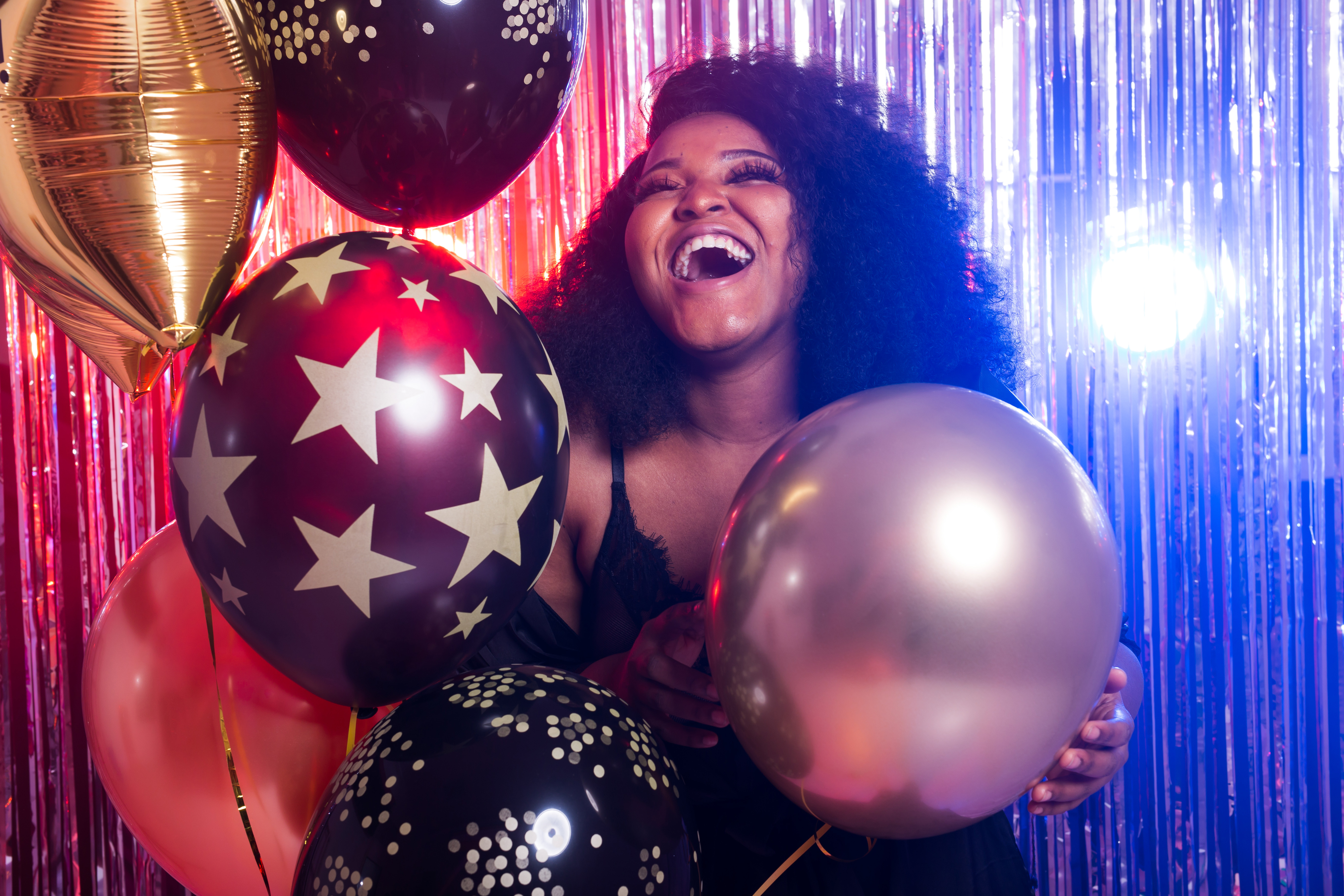 Portrait of a beautiful african american woman against twinkling background. Birthday party