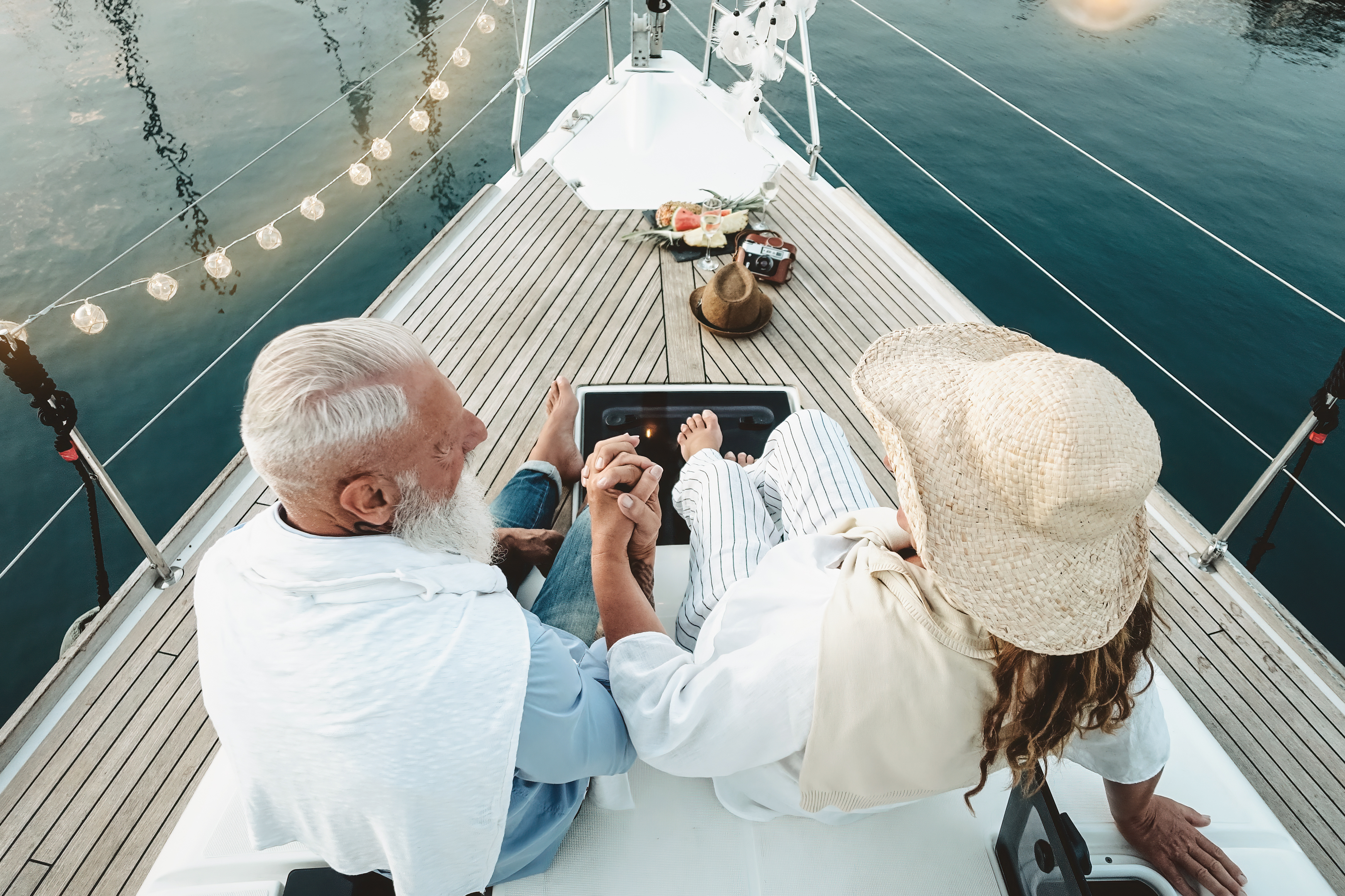 Senior couple celebrating wedding anniversary on sailboat